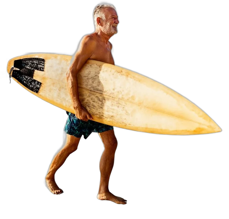 Man carrying a surfboard to the beach